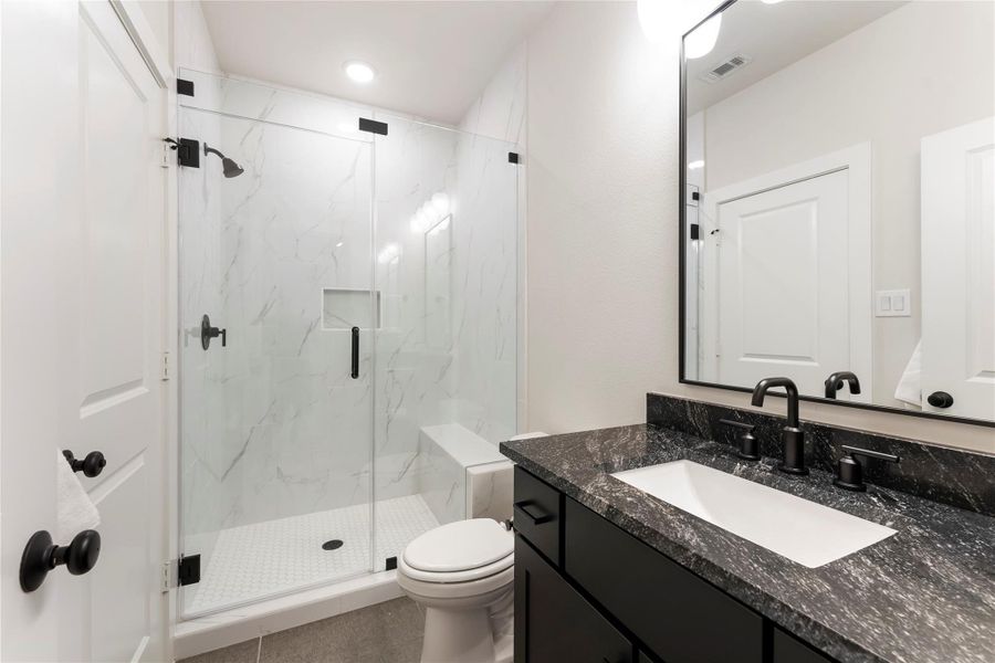 Frameless glass shower, sleek vanity, and upgraded finishes. The design gives each bedroom a more private and elevated daily experience.