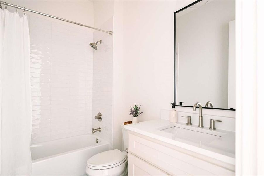 Full bathroom with shower / bath combo, vanity, and toilet