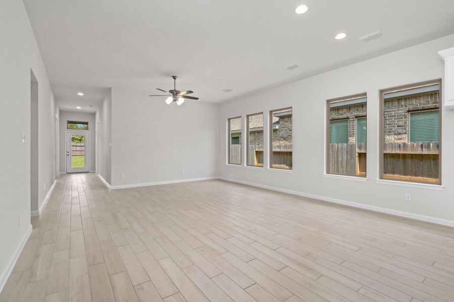 Spacious living area with large backyard-facing windows that bring in natural light.