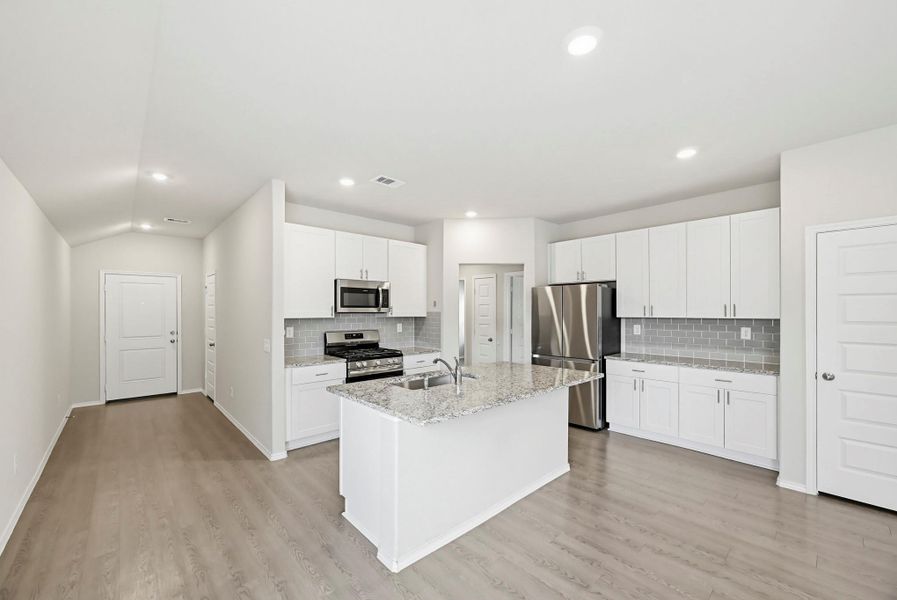 Crisp white cabinetry and subway tiles create a modern look in the kitchen.