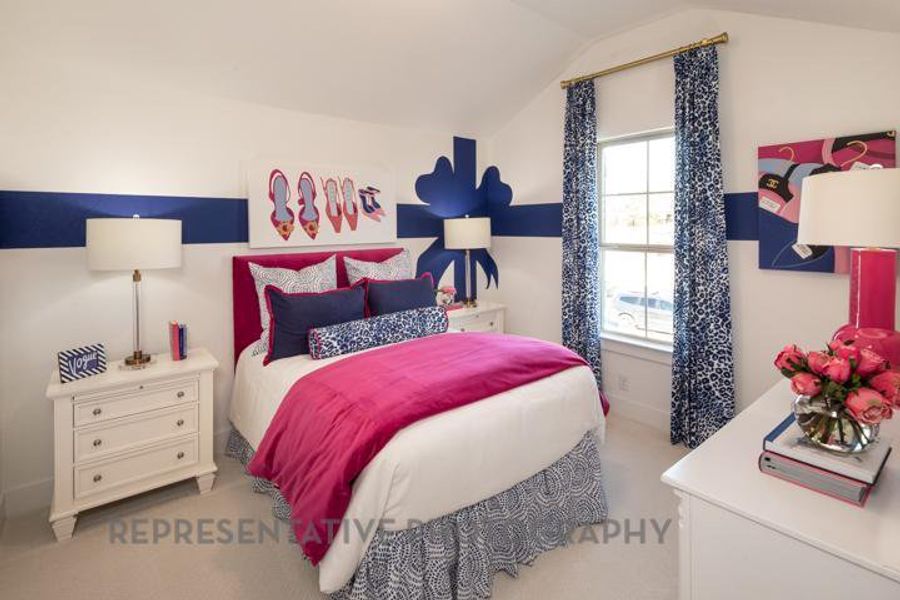 Carpeted bedroom featuring vaulted ceiling Carpeted bedroom featuring vaulted ceiling