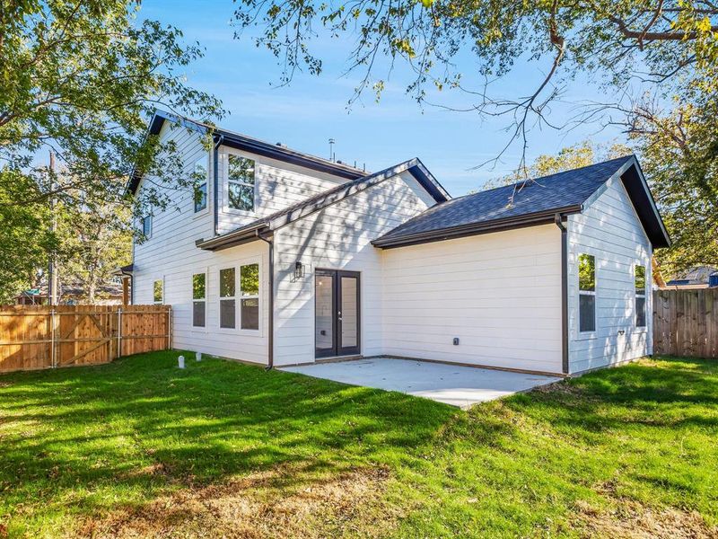 Rear view of property featuring a fenced backyard and a patio