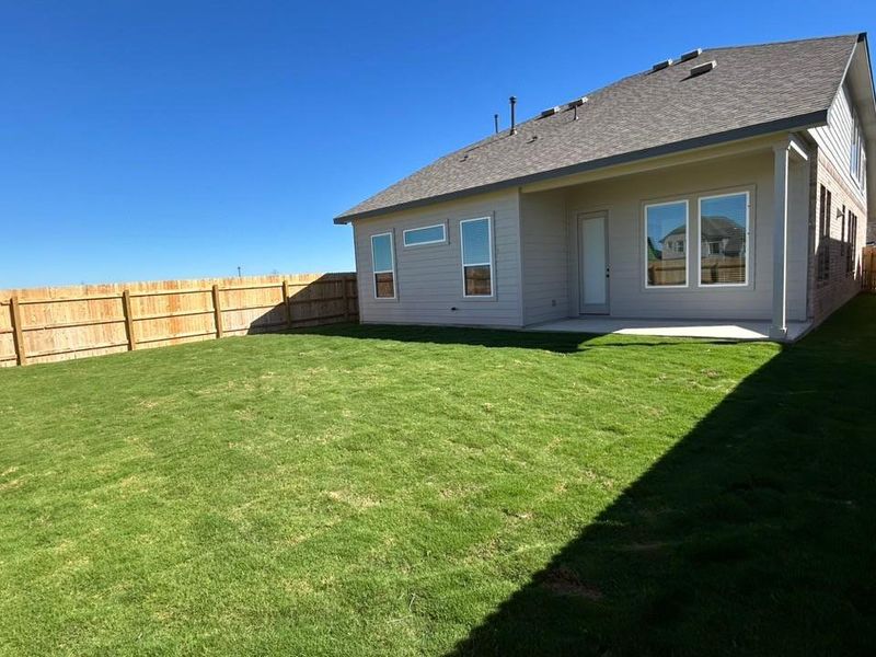 Rear view of property with a patio area, a shingled roof, and a fenced backyard Rear view of property with a patio area, a shingled roof, and a fenced backyard