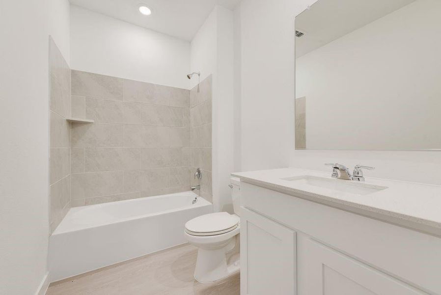 Full bathroom featuring vanity,  shower combination, and wood finished floors