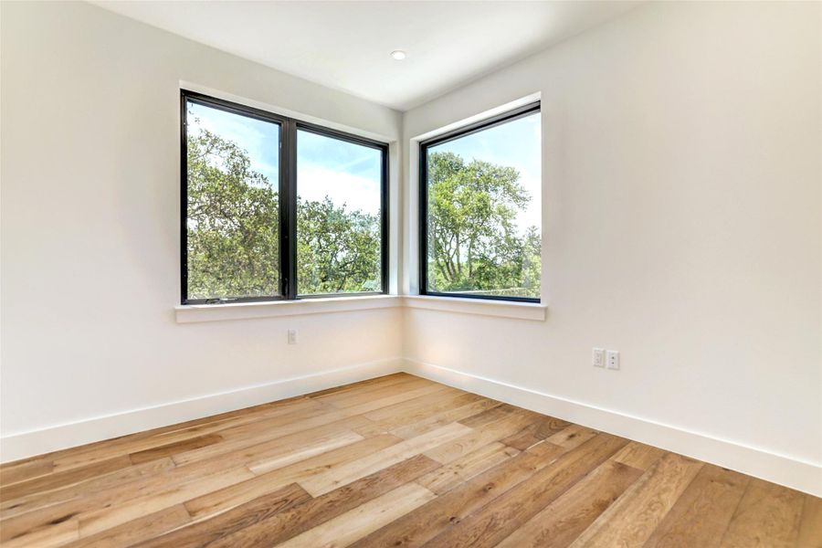 Spare room featuring baseboards and light wood-style flooring