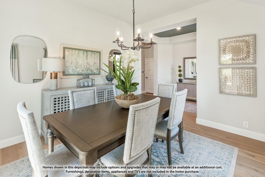 Dining room with dark wood table, upholstered chairs, chandelier, and hardwood floors Dining room with dark wood table, upholstered chairs, chandelier, and hardwood floors