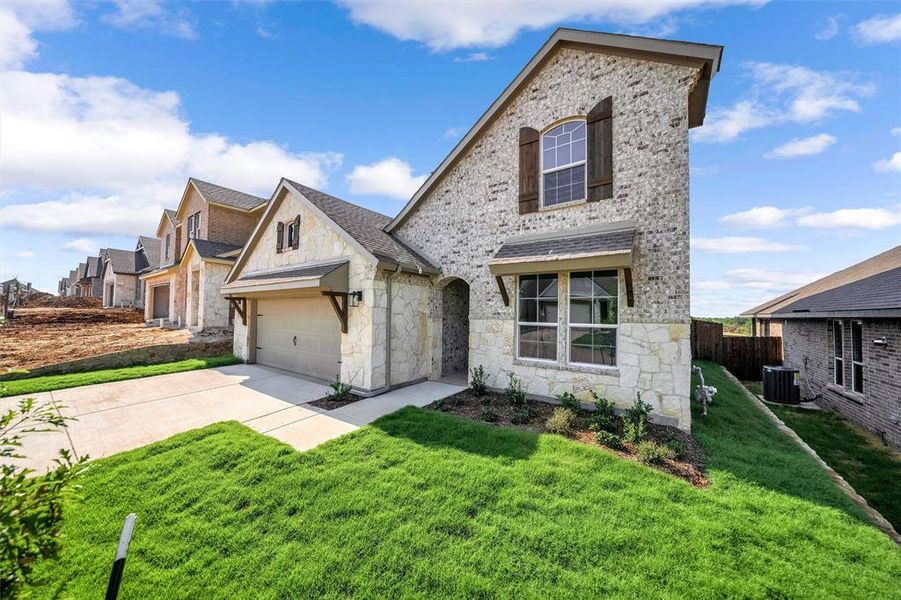 Front exterior of a new home in Liberty Pointe, Gainesville, TX, highlighting curb appeal (Image 21). Front exterior of a new home in Liberty Pointe, Gainesville, TX, highlighting curb appeal (Image 21).