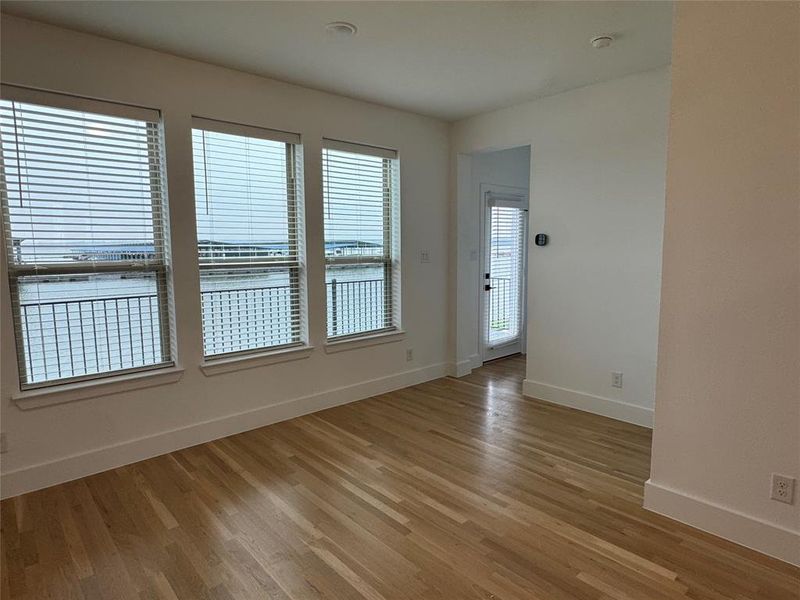 Empty room featuring baseboards and light wood finished floors