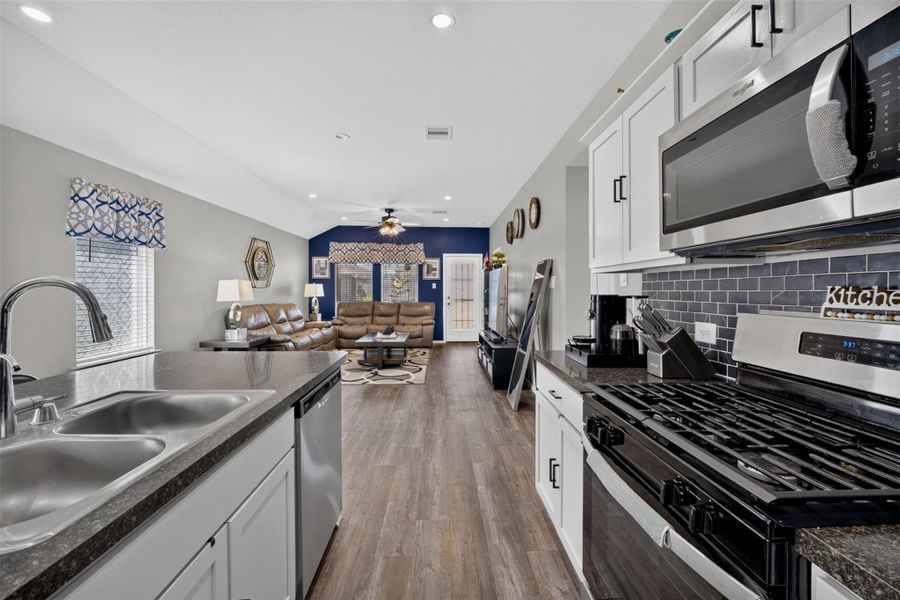 Another look at the kitchen showcasing stainless steel appliances, abundant cabinetry and plenty of workspace. Another look at the kitchen showcasing stainless steel appliances, abundant cabinetry and plenty of workspace.