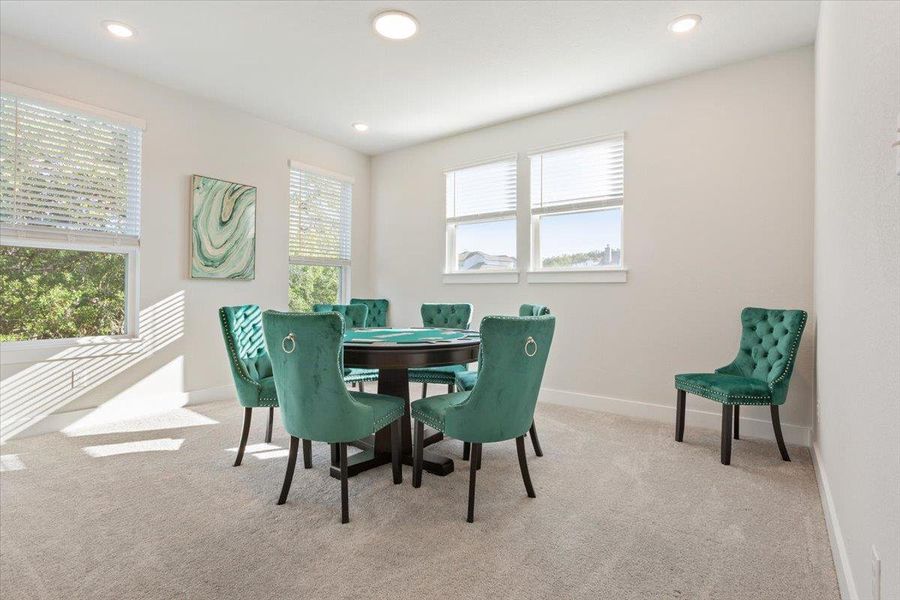 Game with light carpet, windows with tree lined views, and recessed lighting
