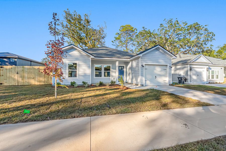 Front exterior of a new home in Live Oak Cottages, Freeport, FL, highlighting curb appeal (Image 24). Front exterior of a new home in Live Oak Cottages, Freeport, FL, highlighting curb appeal (Image 24).