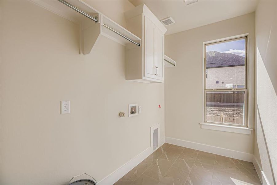 Laundry room with washer hookup, hookup for a gas dryer, and cabinet space Laundry room with washer hookup, hookup for a gas dryer, and cabinet space