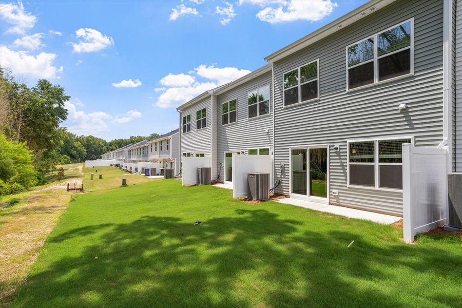 Exterior details and patio area of a home in West Main Townhomes, Sanford (Image 3).
