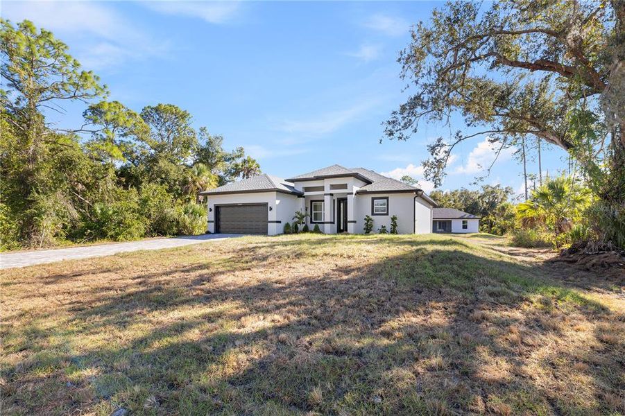 Front exterior of a new home in , Port Charlotte, FL, highlighting curb appeal (Image 23).