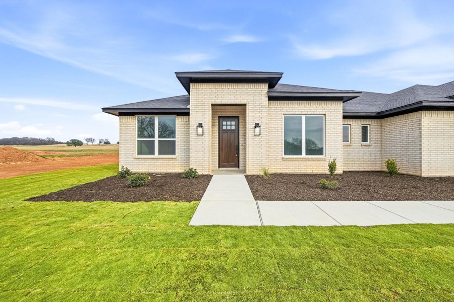 Front exterior of a new home in Taylor Ranch, Springtown, TX, highlighting curb appeal (Image 2).
