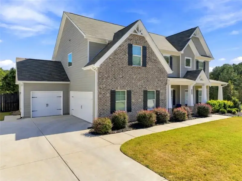 Front exterior of a new home in Joel's Landing, Monroe, GA, highlighting curb appeal (Image 21).