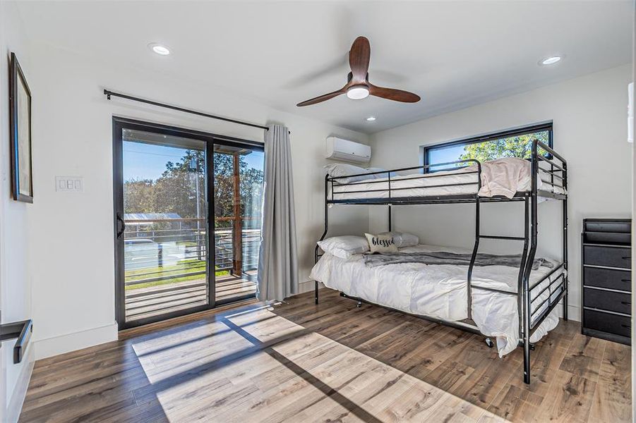 Bedroom featuring access to exterior, wood finished floors, ceiling fan, and recessed lighting
