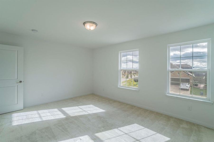 Spare room featuring light carpet and baseboards Spare room featuring light carpet and baseboards