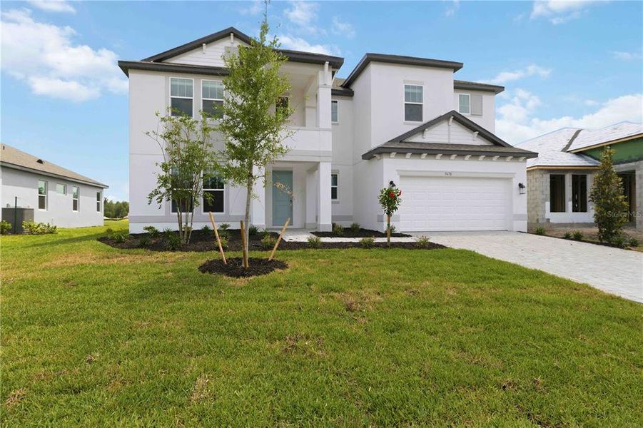 Front exterior of a new home in Creeks Edge at Twin Rivers, Parrish, FL, highlighting curb appeal (Image 29).