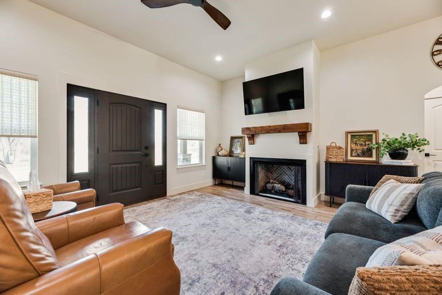 Amazing Living room with Stone fireplace, gas starter logs, and custom firebox that looks like a piece of artwork! 
Custom fabricated mantle and 10 foot ceilings