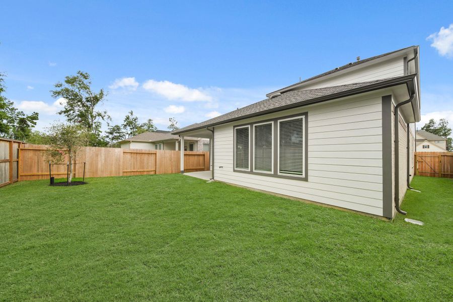 Front exterior of a new home in Barton Creek Ranch, Conroe, TX, highlighting curb appeal (Image 15). Front exterior of a new home in Barton Creek Ranch, Conroe, TX, highlighting curb appeal (Image 15).