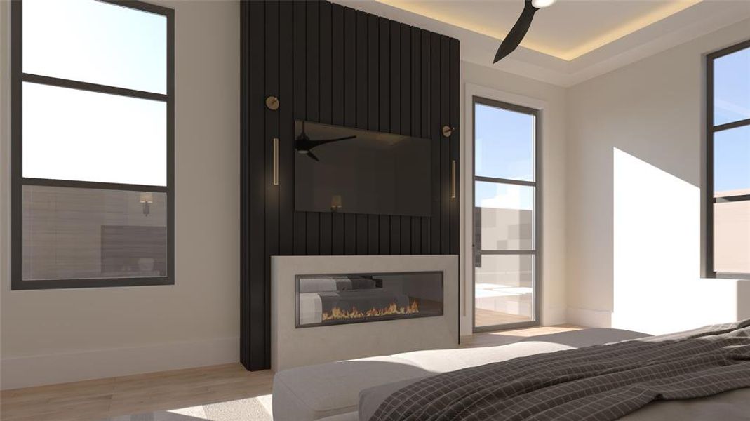 Bedroom featuring a glass covered fireplace and light wood-style floors