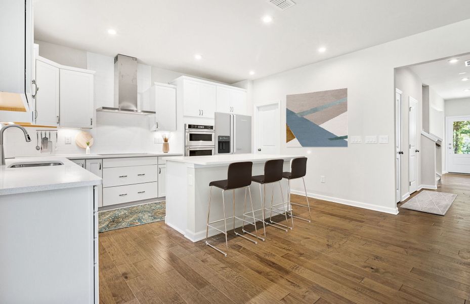 Bright Open Kitchen with elegant engineered wood flooring.
