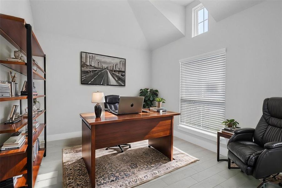 Nestled away quietly in the front of the home is the handsome and grand home office! Featuring high ceilings, custom paint, tile flooring, and large window with privacy blinds!