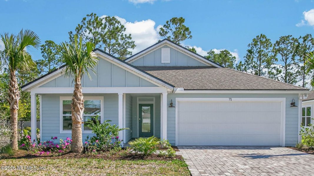 Front exterior of a new home in American Village, Palm Coast, FL, highlighting curb appeal (Image 2).