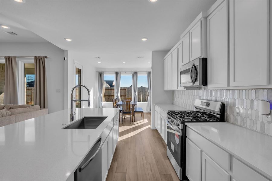 Kitchen to Dining: Designed for real life, this kitchen delivers generous prep space, gas cooking, and a large island that anchors the room. The dining area sits just beyond, filled with natural light and positioned for easy everyday meals or relaxed gatherings. Kitchen to Dining: Designed for real life, this kitchen delivers generous prep space, gas cooking, and a large island that anchors the room. The dining area sits just beyond, filled with natural light and positioned for easy everyday meals or relaxed gatherings.