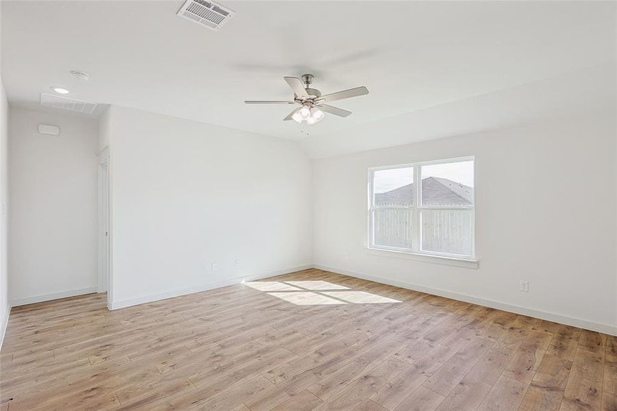 Unfurnished room with ceiling fan and light hardwood / wood-style flooring