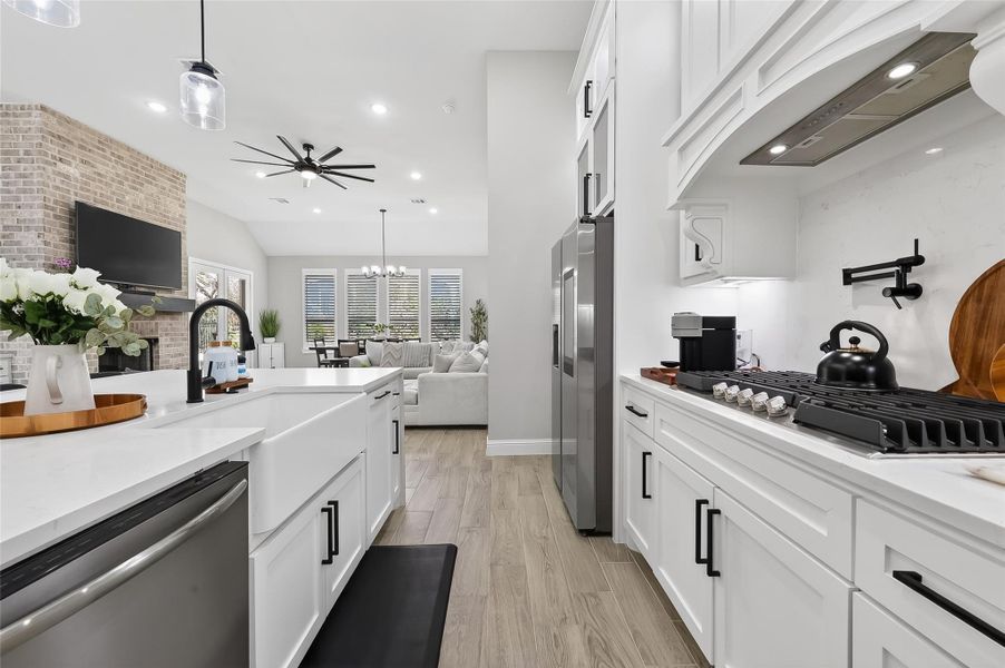Kitchen view showcasing expansive counters and open sightlines to living area. Kitchen view showcasing expansive counters and open sightlines to living area.