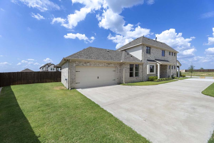 Front exterior of a new home in Elevon, Lavon, TX, highlighting curb appeal (Image 2). Front exterior of a new home in Elevon, Lavon, TX, highlighting curb appeal (Image 2).