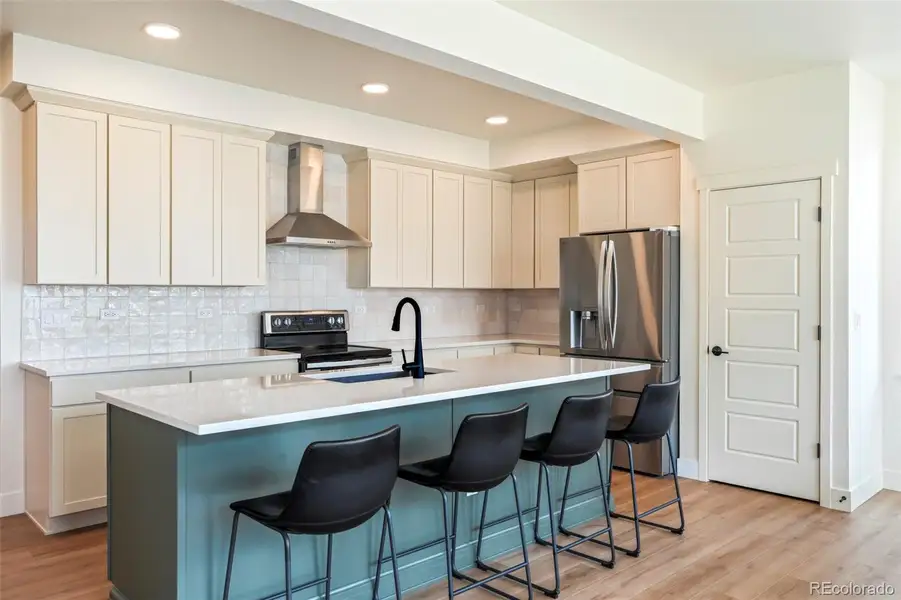 Spacious kitchen with large island, walk-in pantry, and seamless flow into the living area, perfect for everyday living and entertaining in this Three Hills home