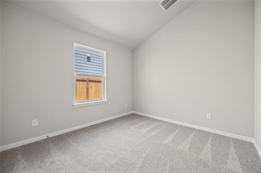 Plush carpeted flooring and a vaulted ceiling define this versatile space. Plush carpeted flooring and a vaulted ceiling define this versatile space.