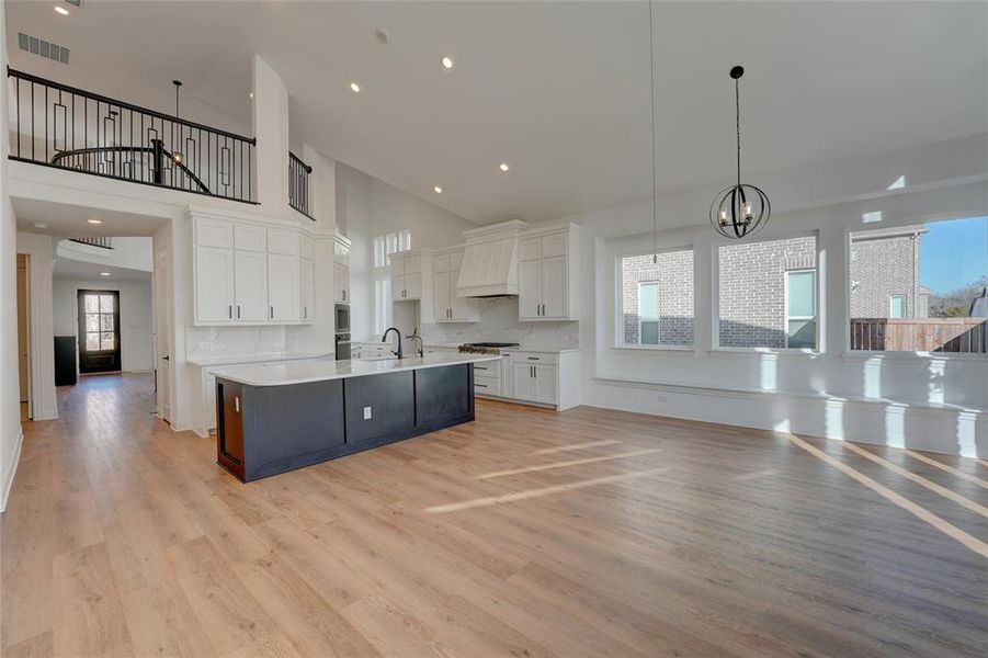 Kitchen featuring white cabinetry, visible vents, light countertops, and vinyl flooring