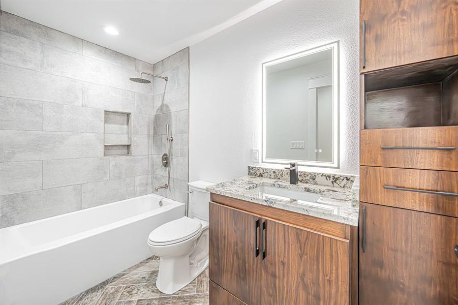 Bathroom featuring washtub / shower combination and vanity Bathroom featuring washtub / shower combination and vanity