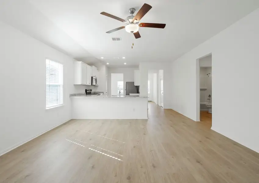Family room and adjoining kitchen with vinyl flooring Family room and adjoining kitchen with vinyl flooring