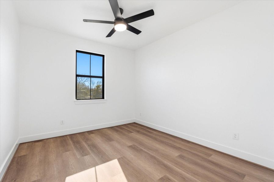 Sleek black windows paired with luxury vinyl flooring flow seamlessly throughout the entire home, not just on the first floor.