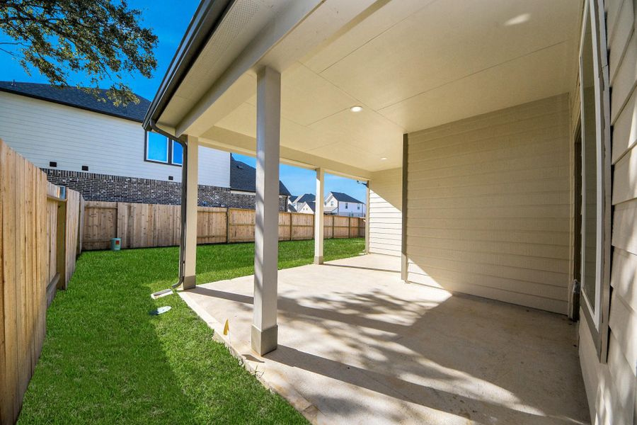 Experience outdoor living at its finest on this expansive covered patio, thoughtfully designed for BBQs and delightful outdoor dining.