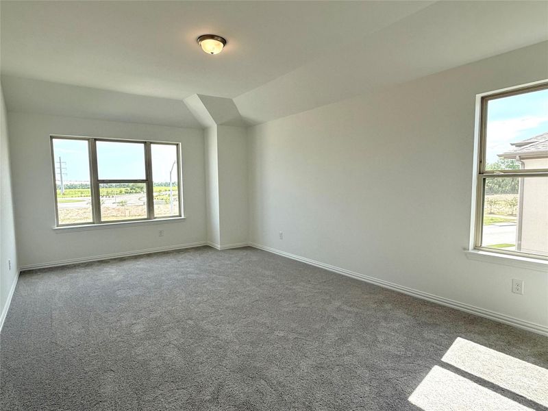 Empty room with carpet floors and vaulted ceiling Empty room with carpet floors and vaulted ceiling