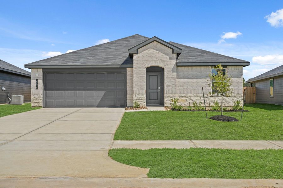 Front exterior of a new home in Grand Pines, Magnolia, TX, highlighting curb appeal (Image 1).