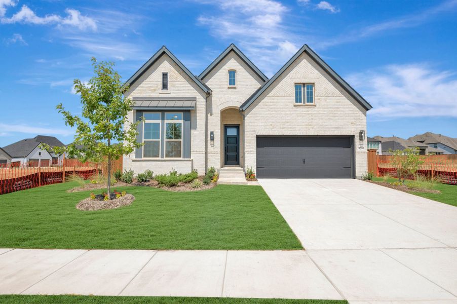 Front exterior of a new home in Sandbrock Ranch, Aubrey, TX, highlighting curb appeal (Image 1). Front exterior of a new home in Sandbrock Ranch, Aubrey, TX, highlighting curb appeal (Image 1).