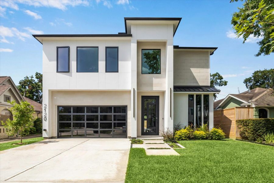 Built in 2025, this stunning luxury home showcases sleek modern architecture with clean lines, expansive windows, and a striking glass and metal garage door. The thoughtfully designed exterior combines sophistication and curb appeal, setting the tone for the elegance found within.