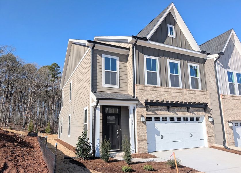 Front exterior of a new home in Ovation at Sweetbrier, Durham, NC, highlighting curb appeal (Image 1).