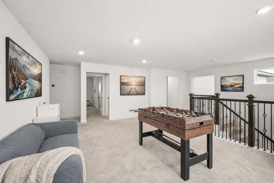 Rec room with light carpet and recessed lighting