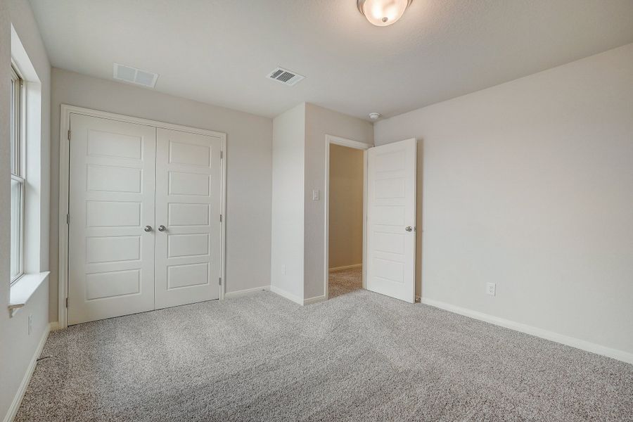 Guest bedroom in the Pearl floorplan at a Meritage Homes community.