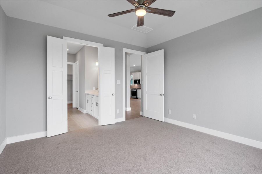 The private primary suite efficiently connects the sleeping area with the dedicated bathroom and generous closet.