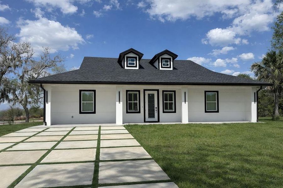 Front exterior of a new home in , Okeechobee, FL, highlighting curb appeal (Image 1). Front exterior of a new home in , Okeechobee, FL, highlighting curb appeal (Image 1).