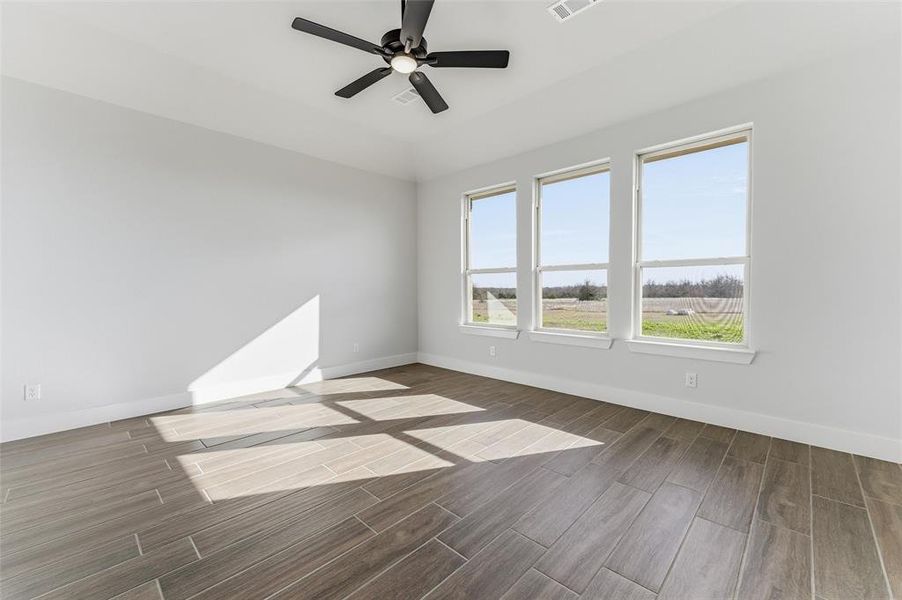 Empty room featuring wood tiled floors and ceiling fan